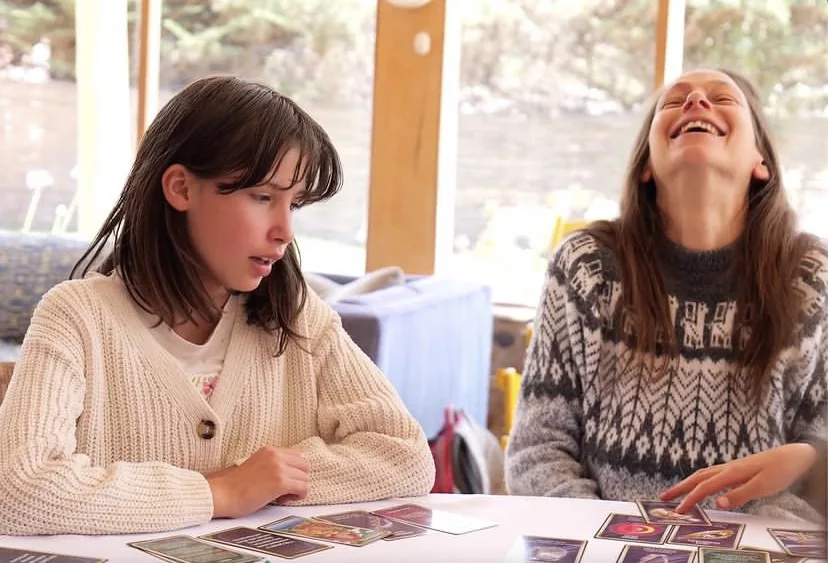 Family members sharing laughter during Sacred Worlds gameplay